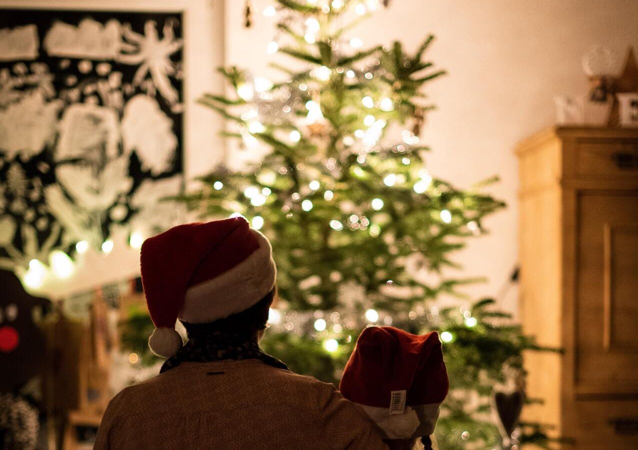 Family in front of Christmas tree