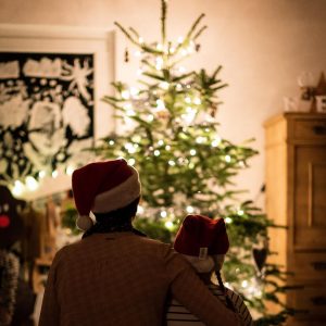 Family in front of Christmas tree