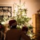 Family in front of Christmas tree