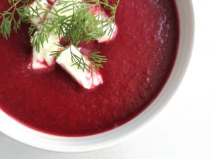 Beetroot soup in bowl with feta and dill