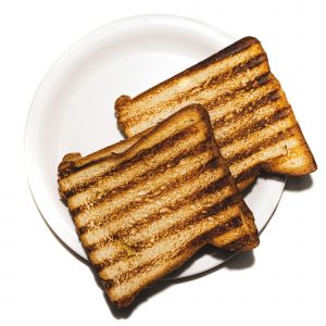 Two pieces of toast with burnt stripes